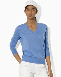 A timeless V-neck sweater rendered in ultra-soft merino wool allows for endless styling options on or off the course.