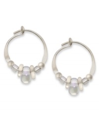 Prismatic shine. Jody Coyote's pretty hoop earrings feature iridescent Czech glass and silver accent beads, set in sterling silver. Approximate diameter: 1/2 inch.