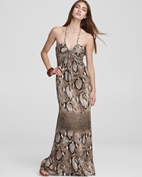 Go long and slither into this stunning maxi-length Sky dress--enriched with a chic snakeskin print and finished with a dramatic halter neckline, this dress takes wearable glamour to the hilt.