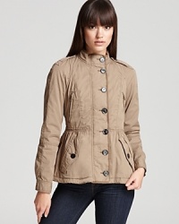 Melding fashion with function, this Burberry Brit anorak features a delicately ruffled waistline and a pleated peplum back for a refreshingly feminine approach to utilitarian silhouette.