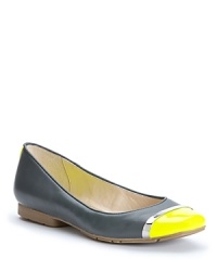 Designer Calvin Klein takes his modern edge into bold, cap toe ballet flats, with metallic accents that define the style.