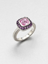 A cushion-cut pink corundum stone surrounded by pavé amethyst stones with a textured sterling silver shank. Pink corundum and amethystSterling silverWidth, about .5Imported 