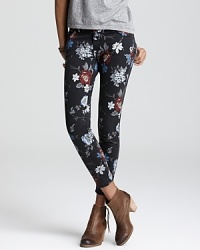 A floral print decorates Current/Elliott's skinny jeans for a cool take on the latest denim trend. Work the low-rise style in downtown fashion-think ankle boots and an asymmetric top.