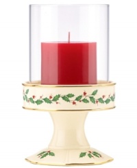 With bands of gold and a holly motif to match the beloved Holiday dinnerware pattern, this porcelain candle holder from Lenox creates instant Christmas ambiance. With red candle and glass shade.