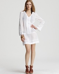 Ondedemar proves beach brights are always just right with this white voile coverup. Teamed with leather flip flops and a wide-brimmed hat, versatile tunic is a cool classic.