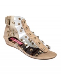 Slicker than your average. With clear rubber straps and all-over gold studs, the Agean flat sandals by Betsey Johnson are strictly for the fearless.