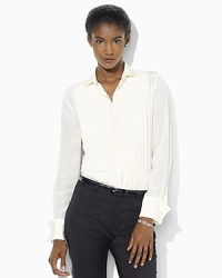 A chic play on a classic menswear staple, this sophisticated tuxedo shirt is tailored for a feminine fit in smooth silk with a pleated front and lustrous pearlized buttons.