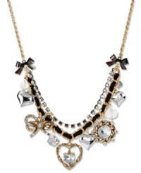 Layer on the loveliness. This frontal necklace from Betsey Johnson boasts hearts and bows accented with glistening crystals. Finished with a black grosgrain ribbon, hematite tone crystal cup chain and bubble hearts. Crafted in antiqued gold tone mixed metal. Approximate length: 16 inches + 3-inch extender. Approximate drop: 1-3/4 inches.