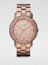 A warm timepiece with a dazzling crystal encrusted bezel. Quartz movementWater resistant to 5 ATMRound rose goldtone stainless steel case, 36mm (1.4)Crystal encrusted bezelRose goldtone dialLogo hour markersSecond hand Rose goldtone stainless steel link braceletImported