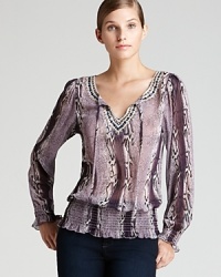 Send your style on an exotic spin with this Shiloh 770 blouse alive with sleek snakeskin print. Sequin embellishment accentuates the tonal palette for a glamorous walk on the wild side.