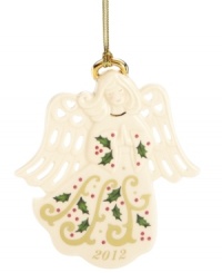 Serene and beautiful, the Joyous Tidings Angel ornament from Lenox is crafted of glazed ivory porcelain with a golden halo, Christmas greenery and pierced hearts in her wings.