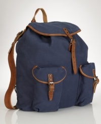 Taking a cue from vintage hiking bags, a rugged canvas backpack is accented with leather trim and multiple pockets for stylish stowing.