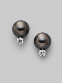 From the South Sea Collection. Classic black cultured pearl studs with sparkling diamond accents, set in 18k gold. 8mm black round cultured pearls Quality: A+ Diamonds, 0.20 tcw 18k white gold Post back Imported