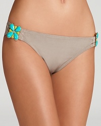 Turquoise-colored, jewelry style accents give this Trina Turk bikini bottom a retro-luxe aesthetic.