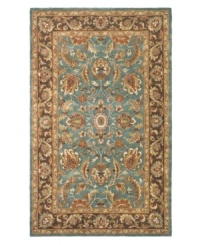 A choice color blue behind a myriad of intricate and vibrant floral medallions creates a simply elegant and rich Persian-inspired rug from Safavieh. Hand-tufted and woven from pure wool by experienced artisans in India, it makes a refined statement wherever placed. (Clearance)