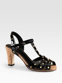 Patent leather silhouette with goldtone studs and a cork heel. Cork heel, 3 (75mm)Patent leather upper with metal studsAdjustable ankle strapLeather lining and solePadded insoleMade in Italy