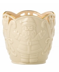 Combining elegant cutwork, gold trim and St. Nick in ivory porcelain, this Merry Lights candle holder shines a light on Christmas.