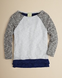 A raglan sleeve layering piece for the chilly months, this slouchy sweater is rendered in a soft, marled knit.